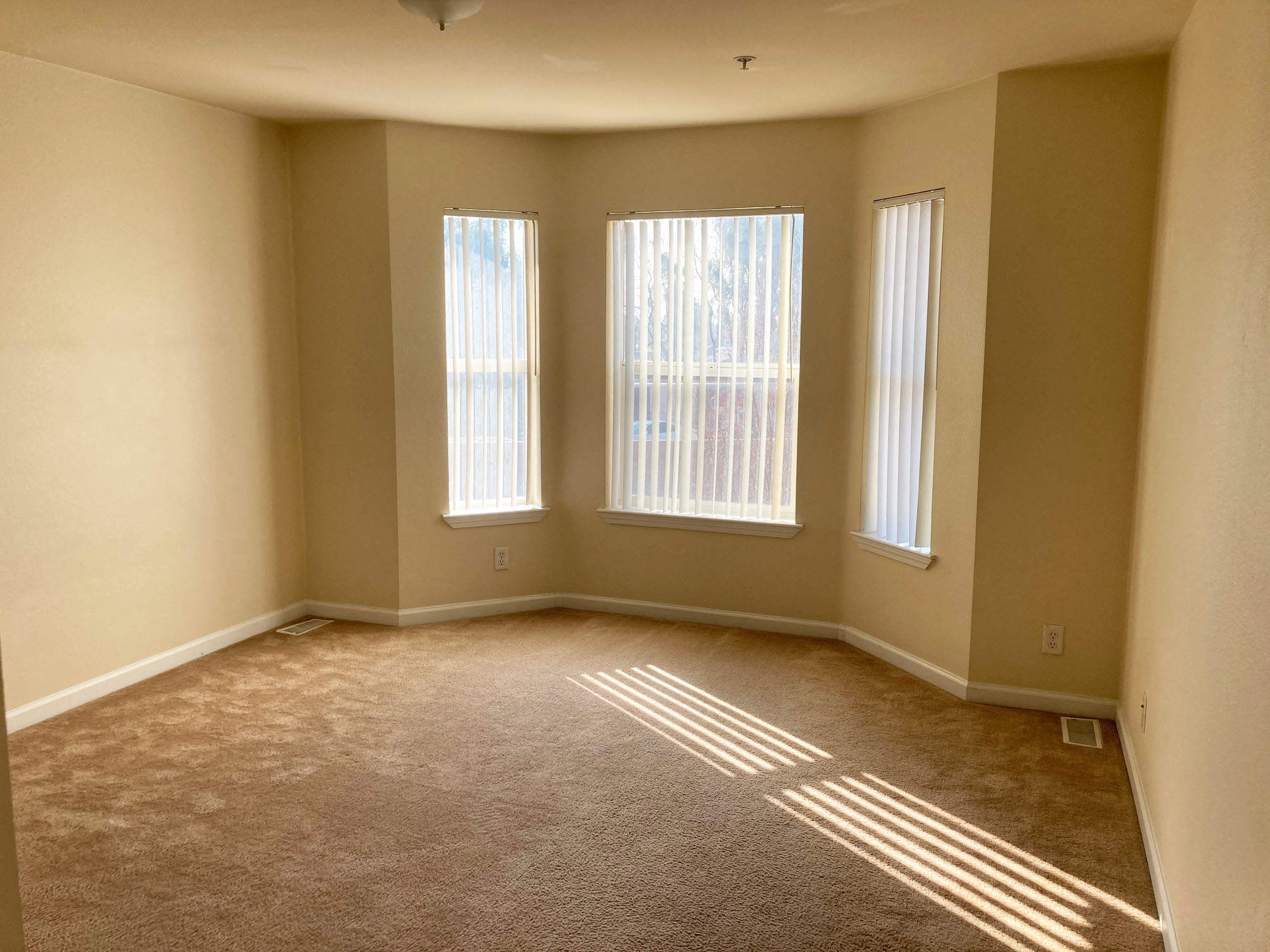 Image of room with large windows and a floor heater